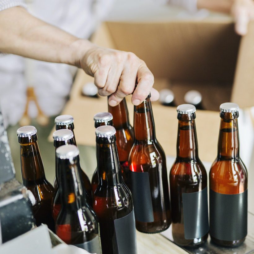 brewery worker preparing beer bottles.jpg